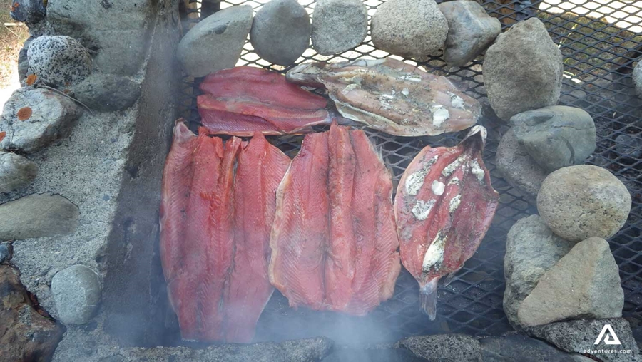 Grilled salmon fish on open fire