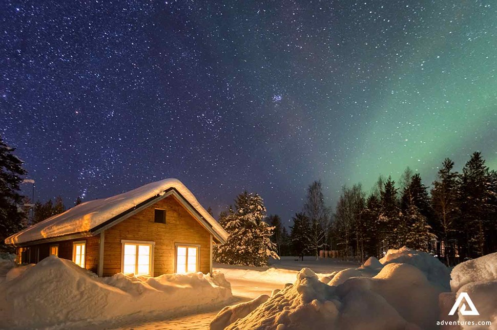 wooden cabin in sweden near northern lights