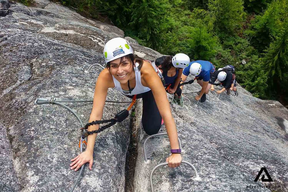 smiling woman rock climbing