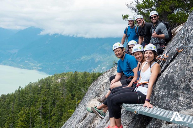 group sitting near a cliff after rock climbing in squamish