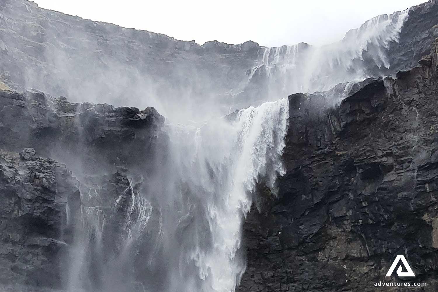 large black cliffs and a waterfall