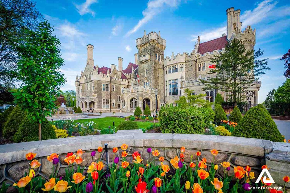 casa loma building view with colourful flowers
