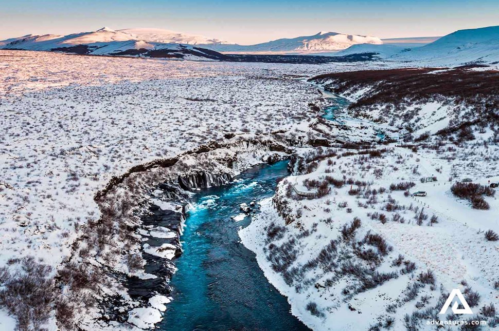 hraunfossar waterfall in winter in iceland