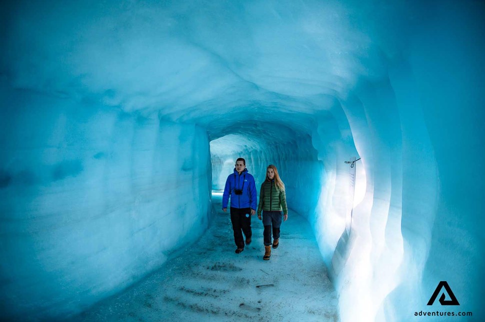 couple walking into the glacier on langjokull