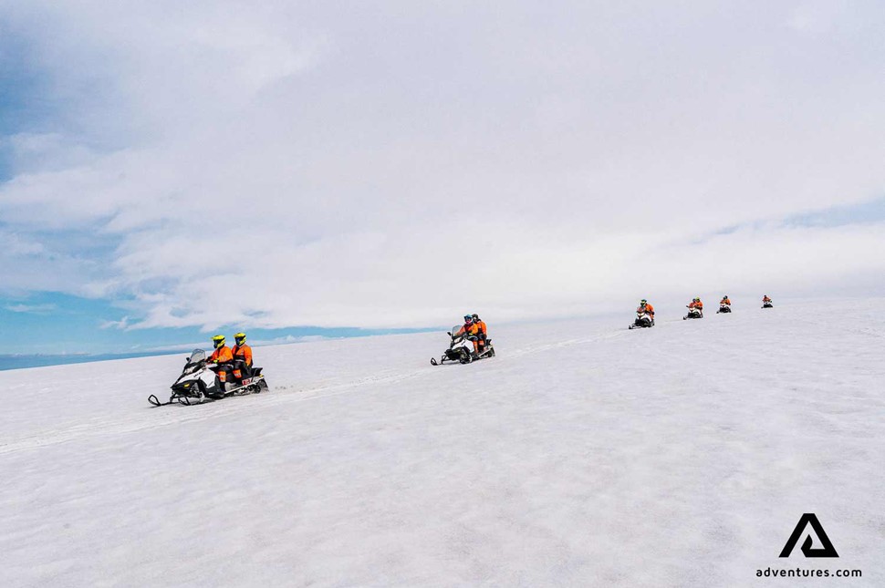 riding on snowmobiles through langjokull in iceland