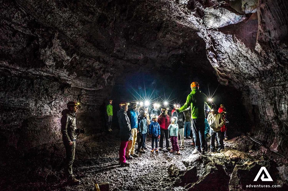 guide with a group in lava cave vidgelmir in iceland