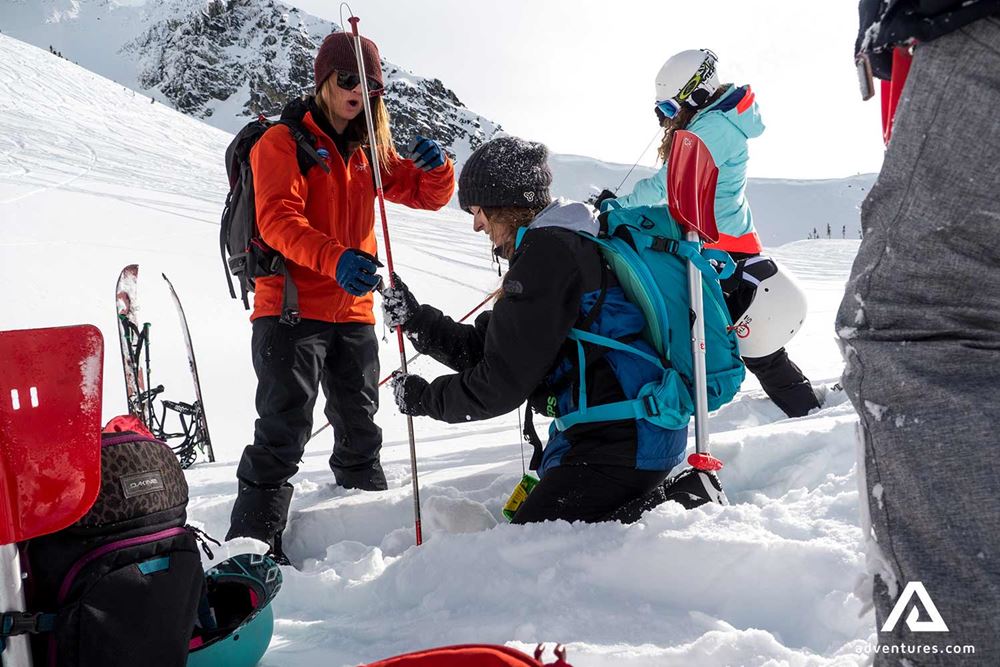 guide helping a skier