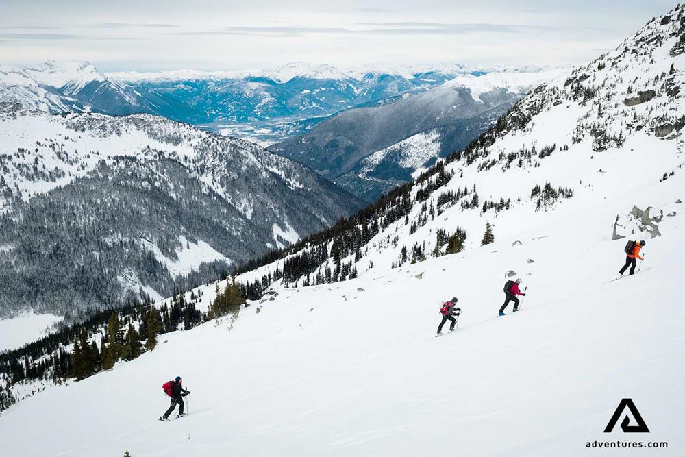 group of skiers skiing up a mountain