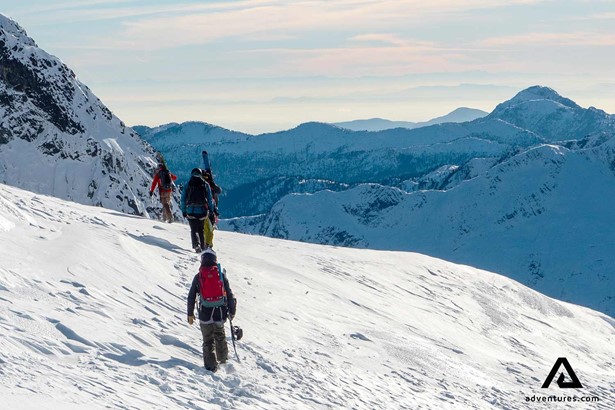 skiers walking in tantalus mountains in canada