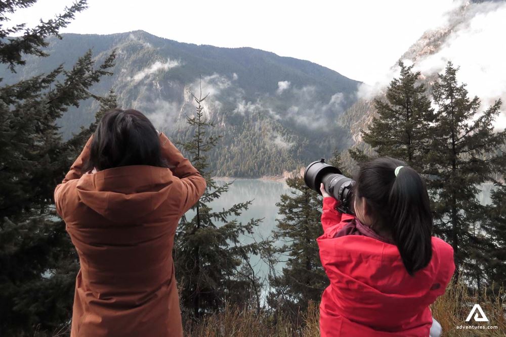 Women taking photos of a landscape