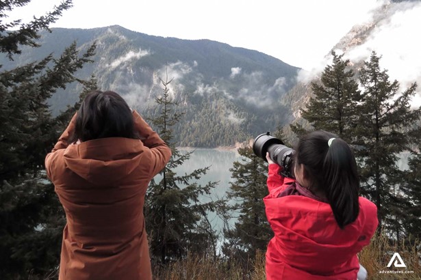 Women taking photograph of a landscape