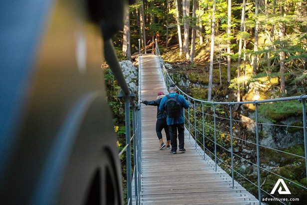 hiker on a wooden suspension bridge
