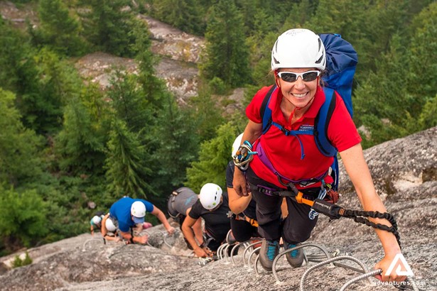 happy woman climbing in squamish