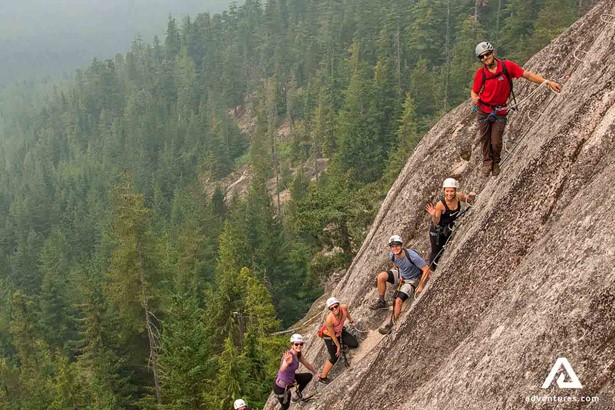 group climbing a steep cliff in squamish