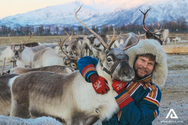 happy man posing with a reindeer in norway