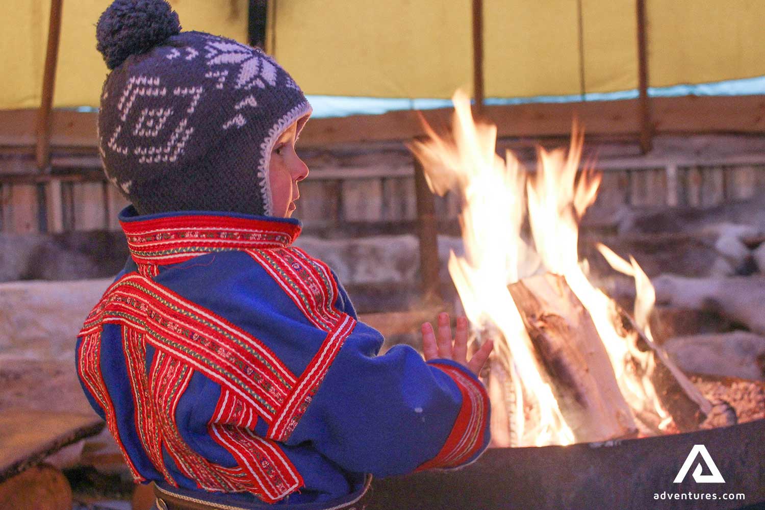 young boy near a campfire in norway