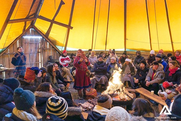 sami culture guide telling stories in a large tent