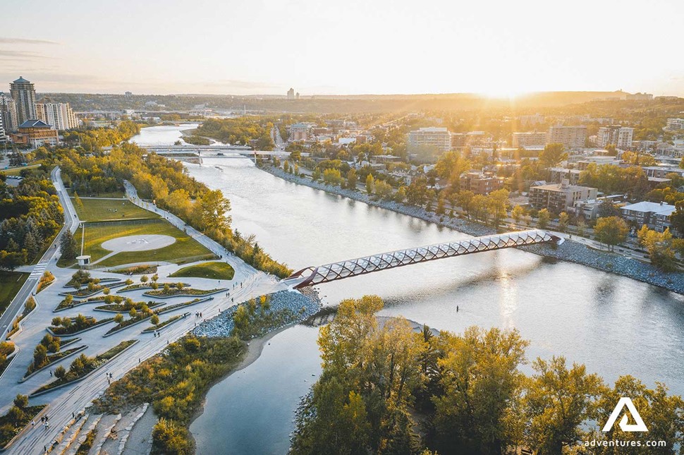 aerial view of calgary city and a bridge above a river in canada at sunset