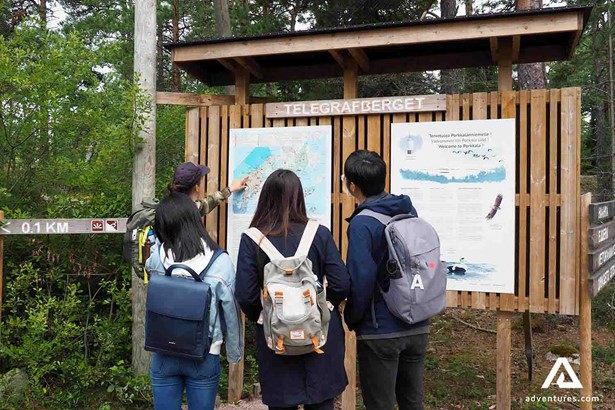 hikers looking at a parks map in porkkala finland