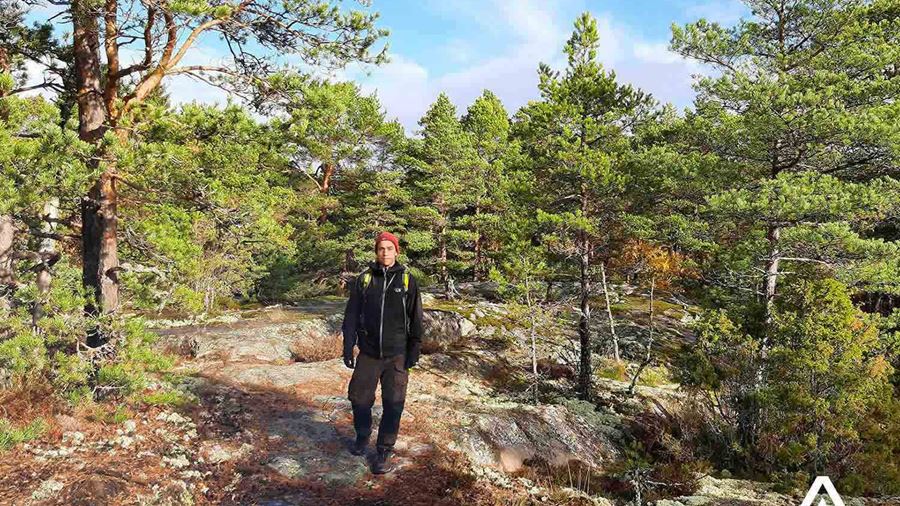 man hiking in the porkkala forest area