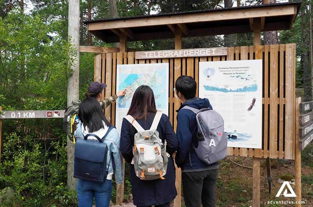 hikers inspecting a park map in porkkala