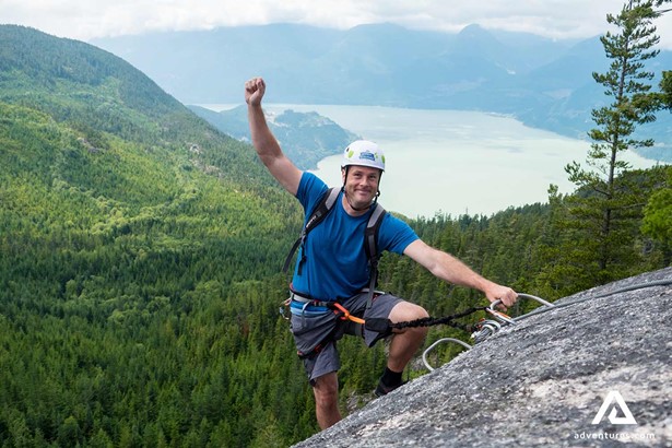 Happy Man On Top Of Mountain rock climbing