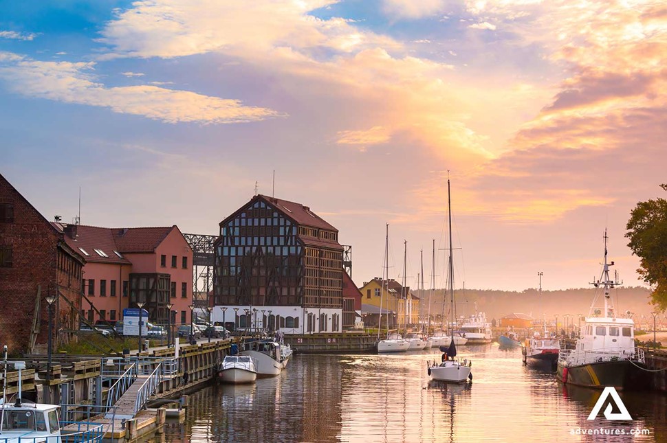 sunset at klaipeda old town harbor with small boats