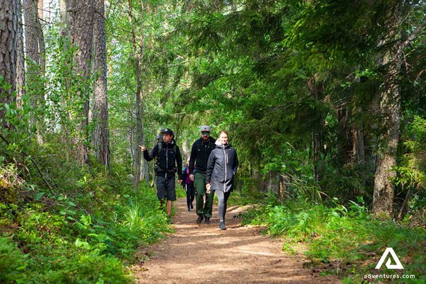 walking through a forest path with friends in finland