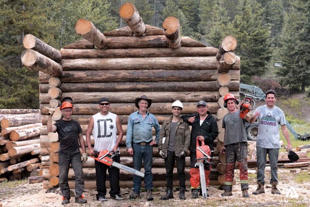 Men on a cabin log building shop