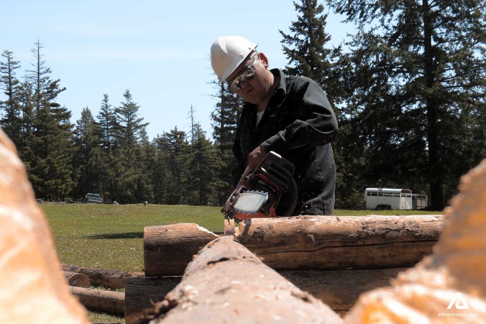 Man building a log cabin