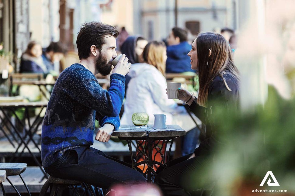 couple having a drink at a bar in the evening