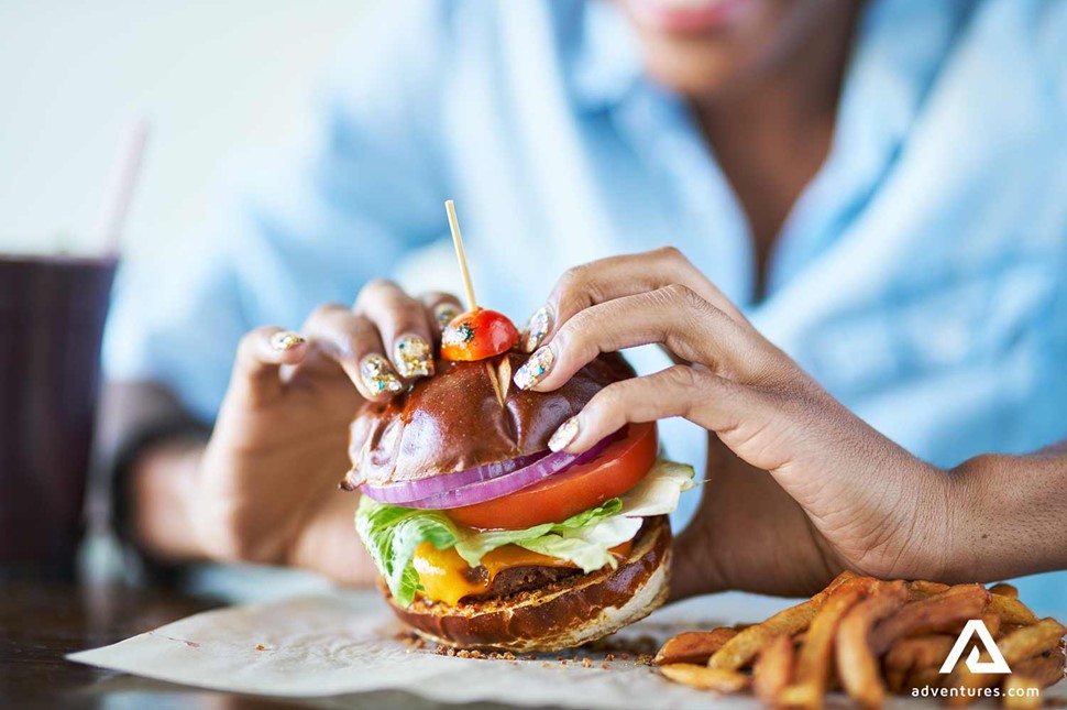 eating a large burger meal