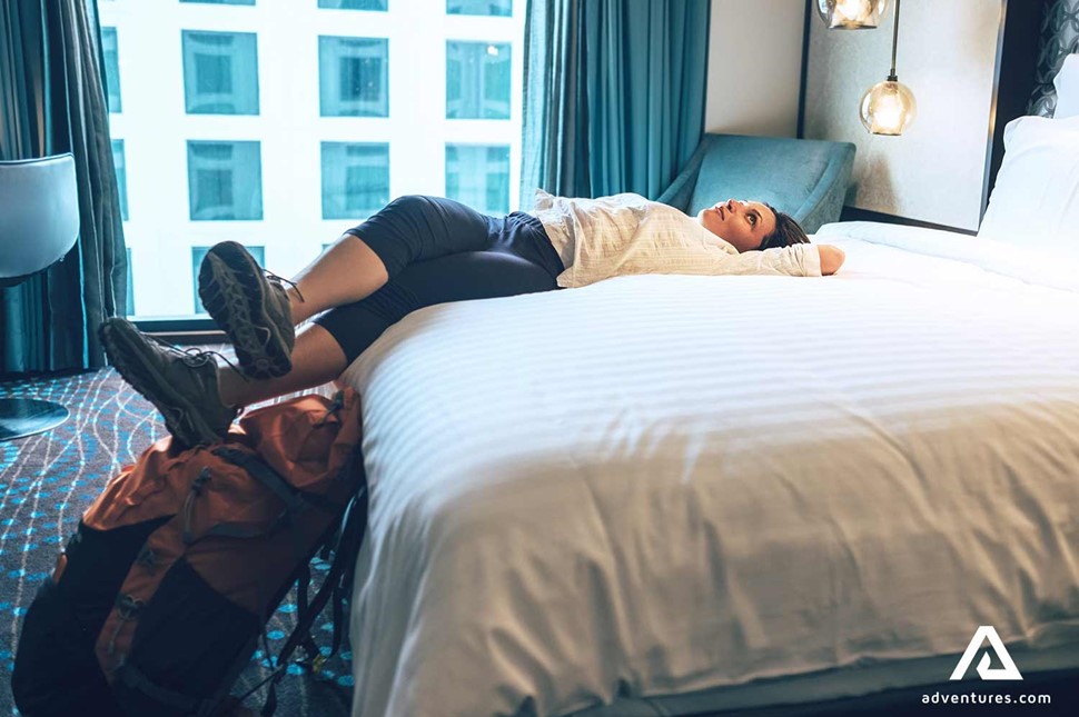 woman relaxing at a hotel room after travelling