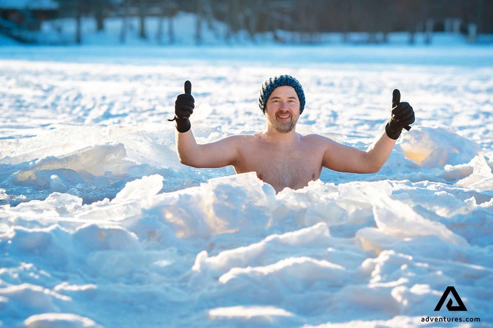 man enjoying a cold winter swim in sweden
