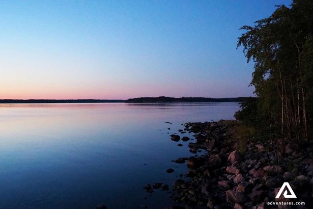 late evening sunlight near a lake in finland