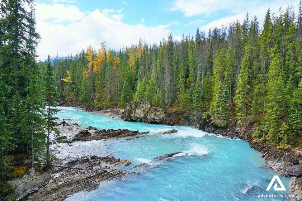 blue glacial water river neat takkaw falls in yoho national park