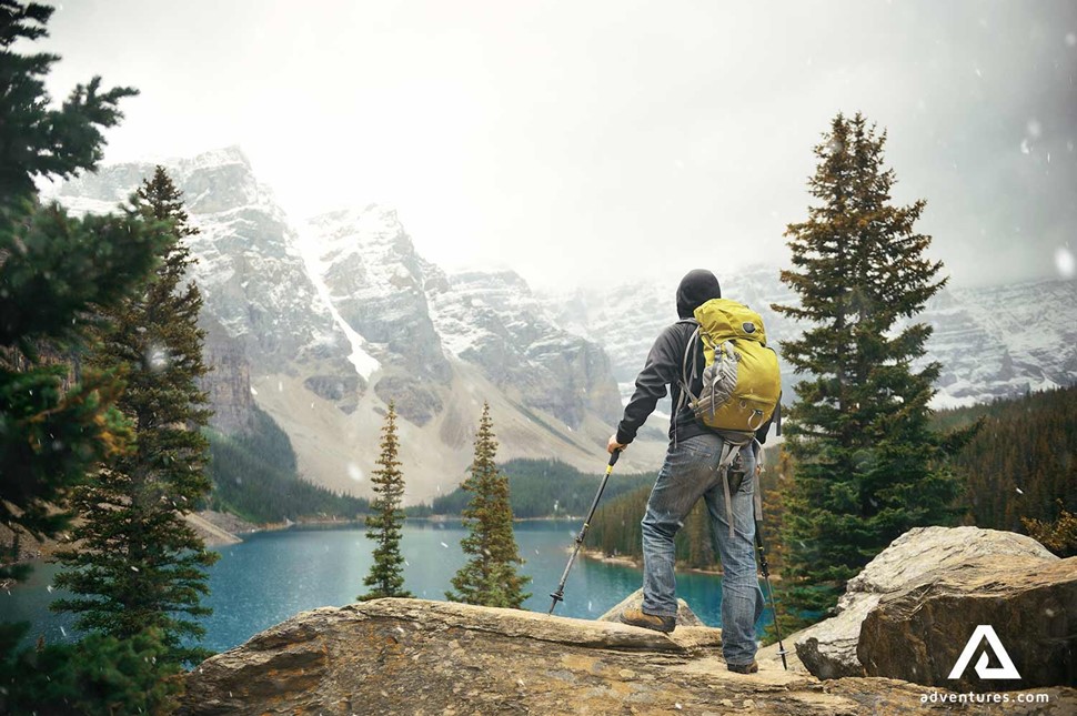 man hiking in yoho national park on a rainy day in canada