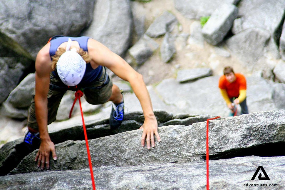 steep cliff mountain climbing man in canada