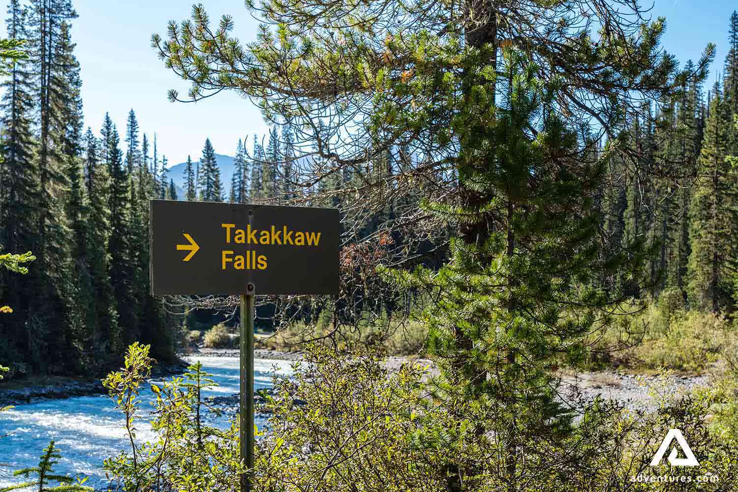 a sign pointing towards takakkaw falls in winter