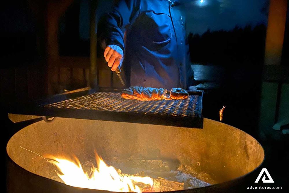 cooking a steak on campfire