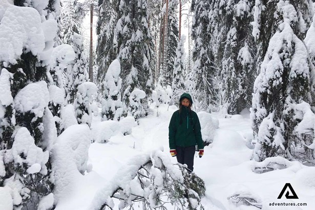 female hiker in a snowy forest in finland