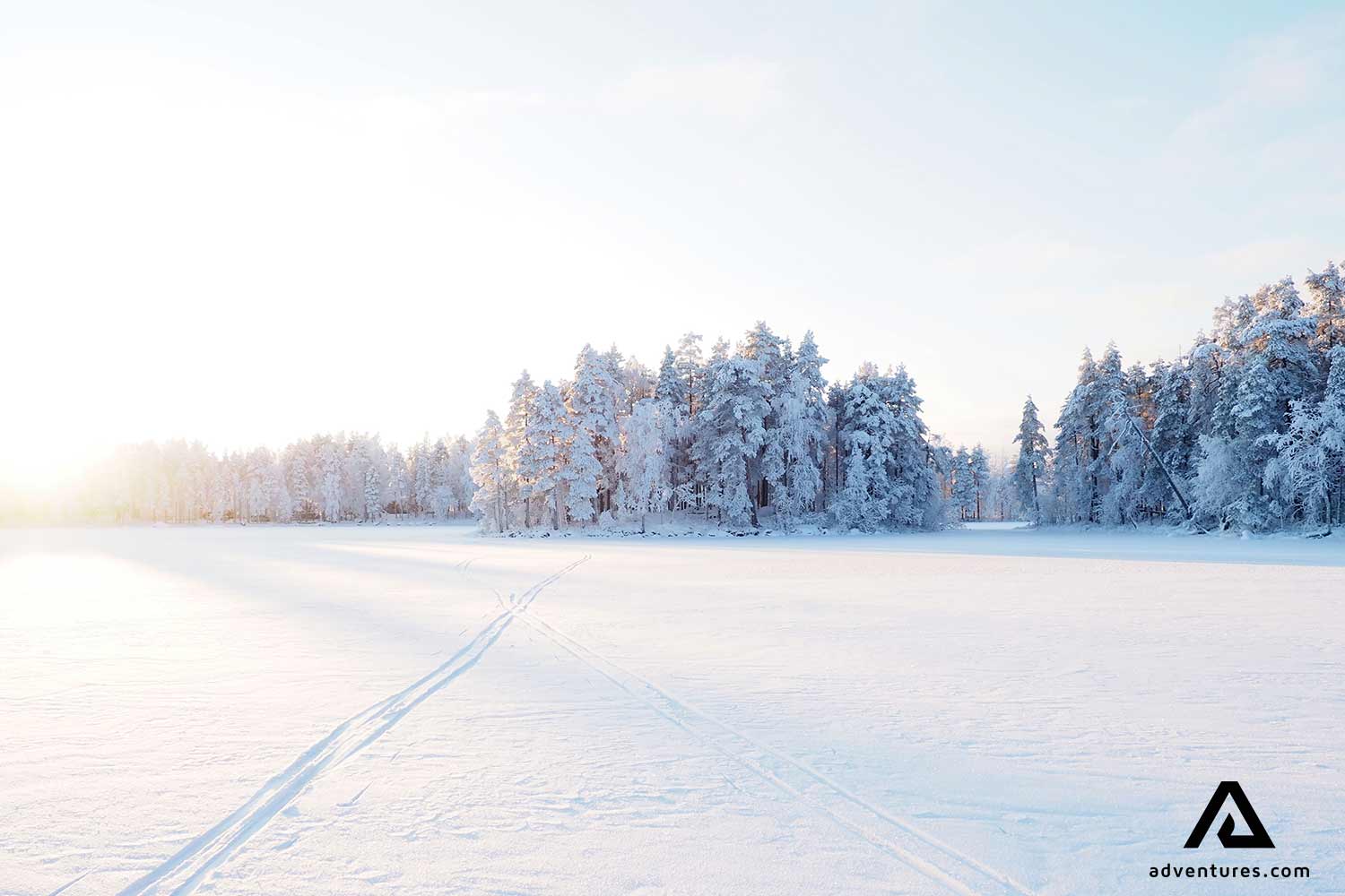 snowy frozen lake at sunrise in liesjarvi
