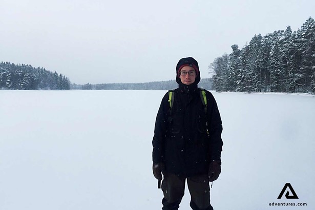 man hiking in winter on a cloudy day in finland