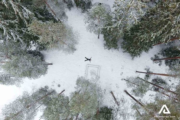 aerial view of a person making a snow angel in finland