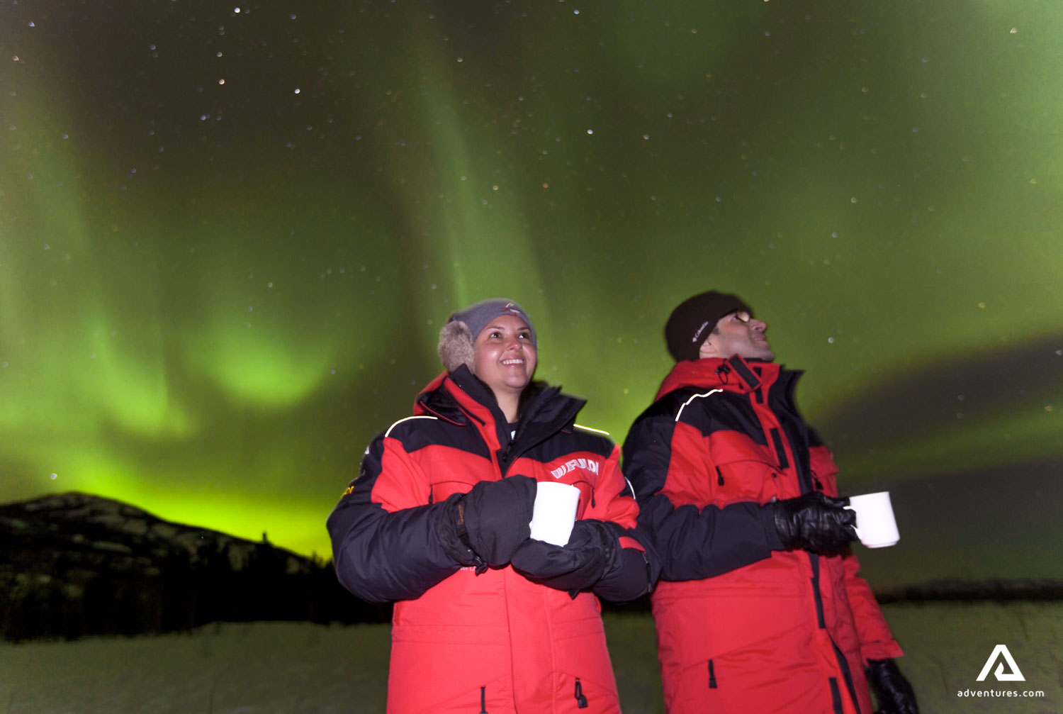 Happy people watching Northern Lights
