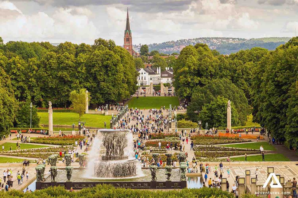 big crowd of people walking in a park in oslo