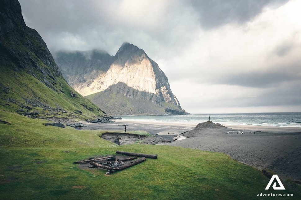 old building remains at kvalvika beach in summer on a cloudy day