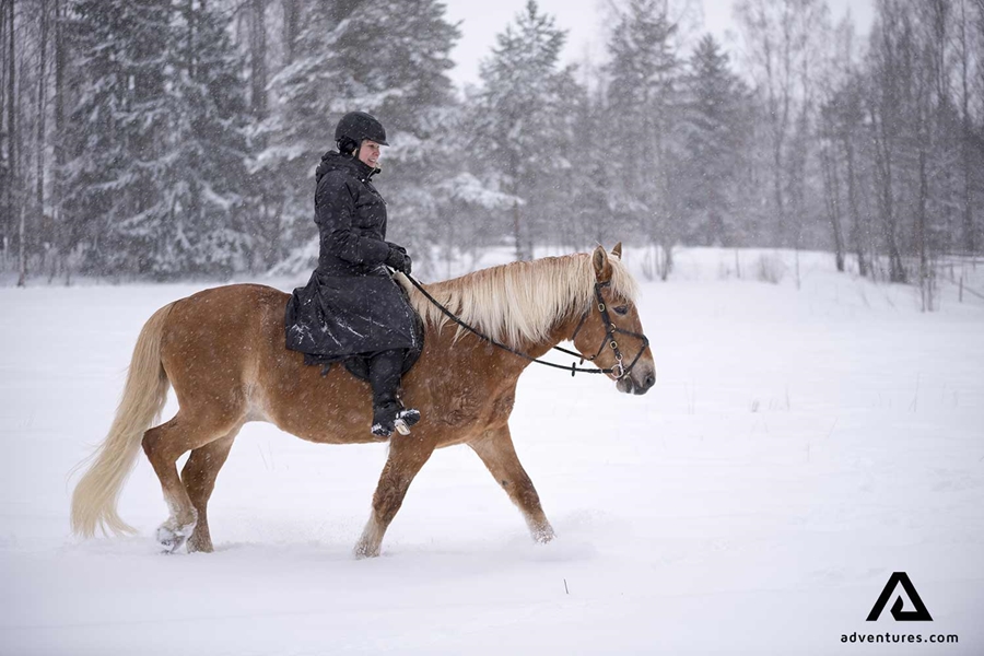 riding a horse in a snowstorm