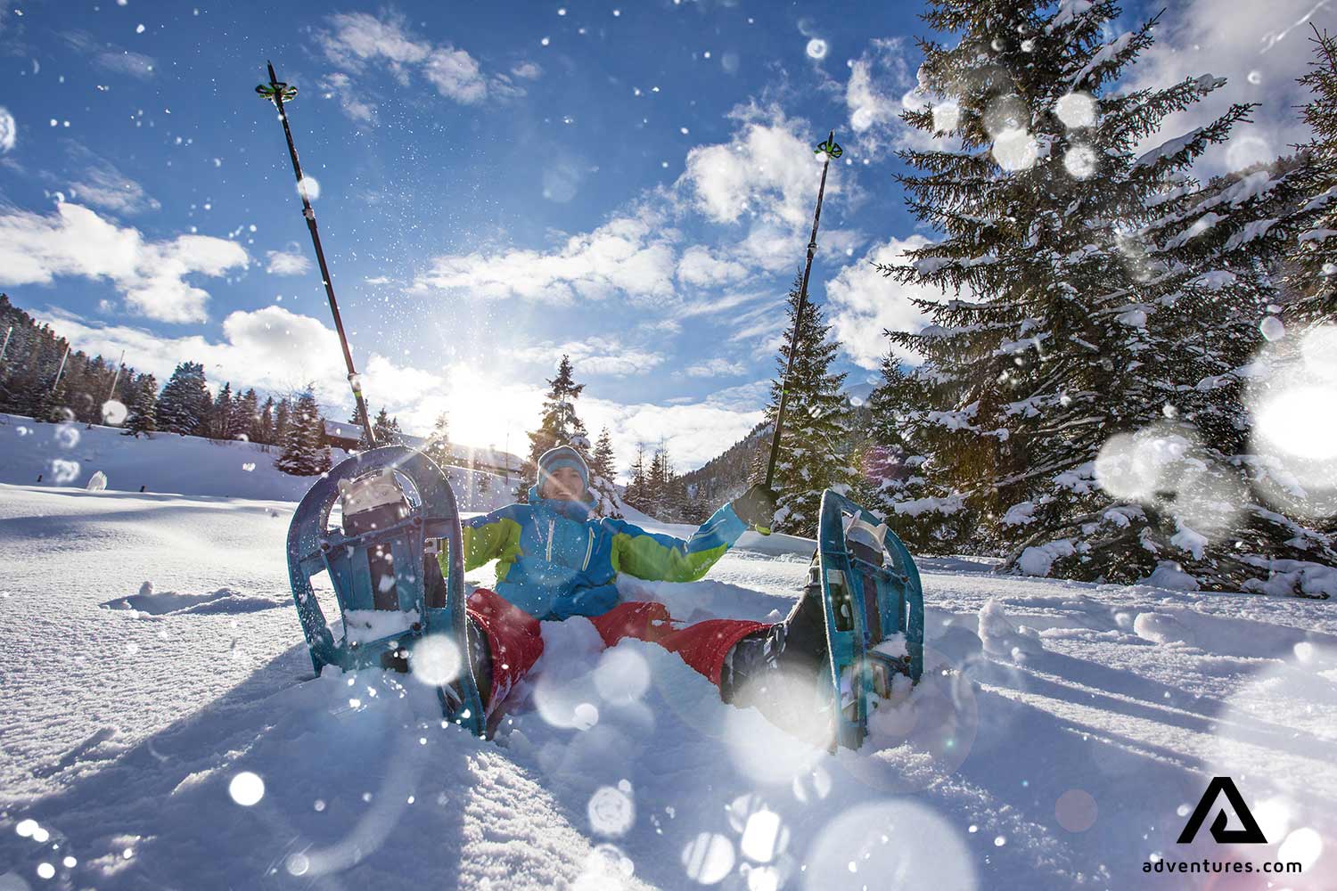 happy hiker with snowshoes in winter