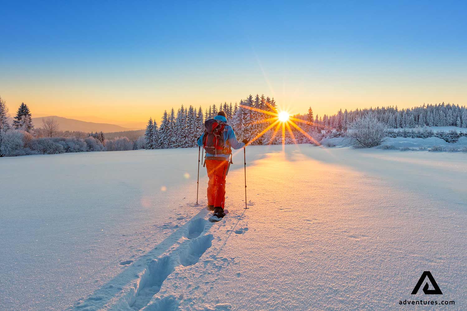 snowshoeing through a snowy field in winter